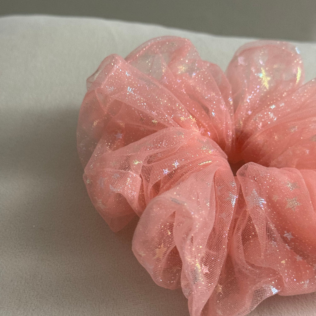 Pink glittery scrunchie on a light background