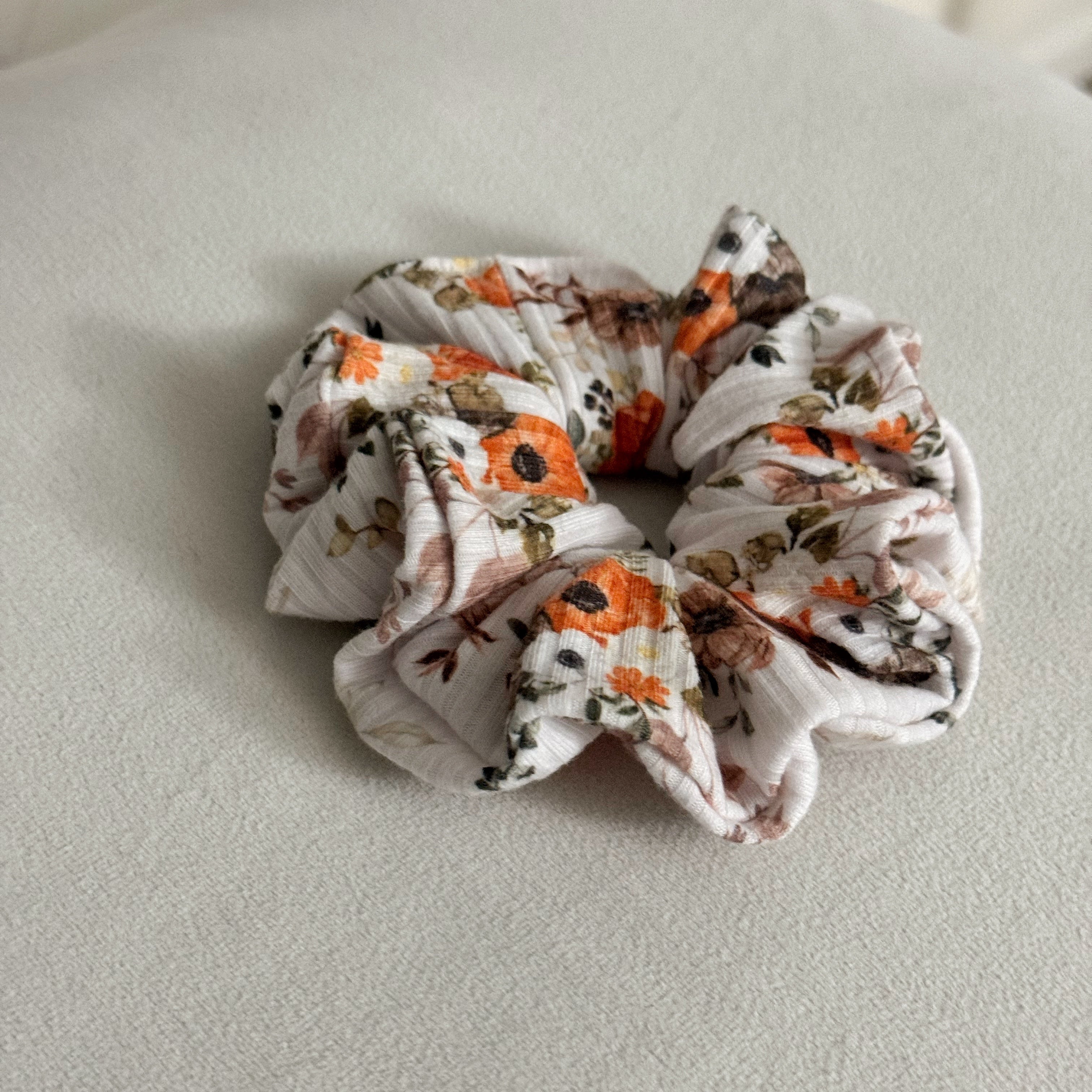Floral patterned scrunchie on a light gray surface