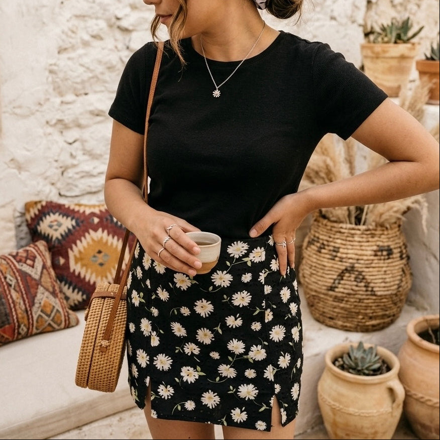 Woman wearing our Millie skirt with a black t-shirt standing in a rustic outdoor setting.