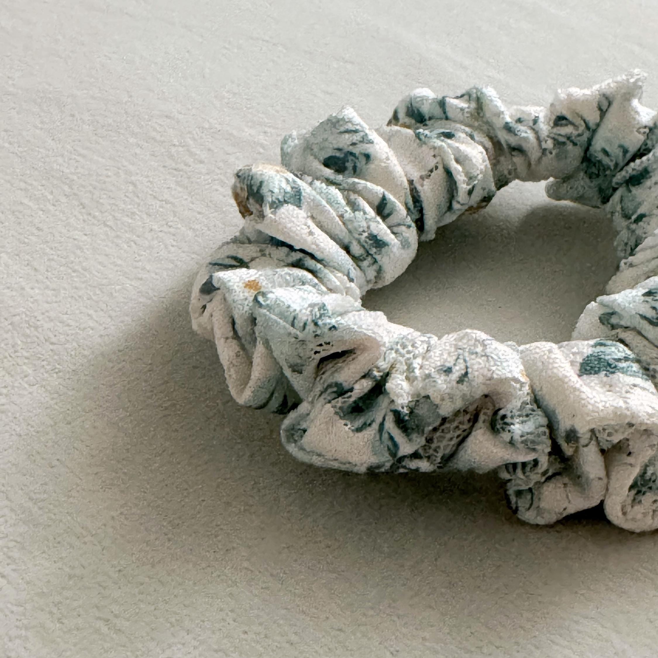 Floral patterned scrunchie on a textured surface