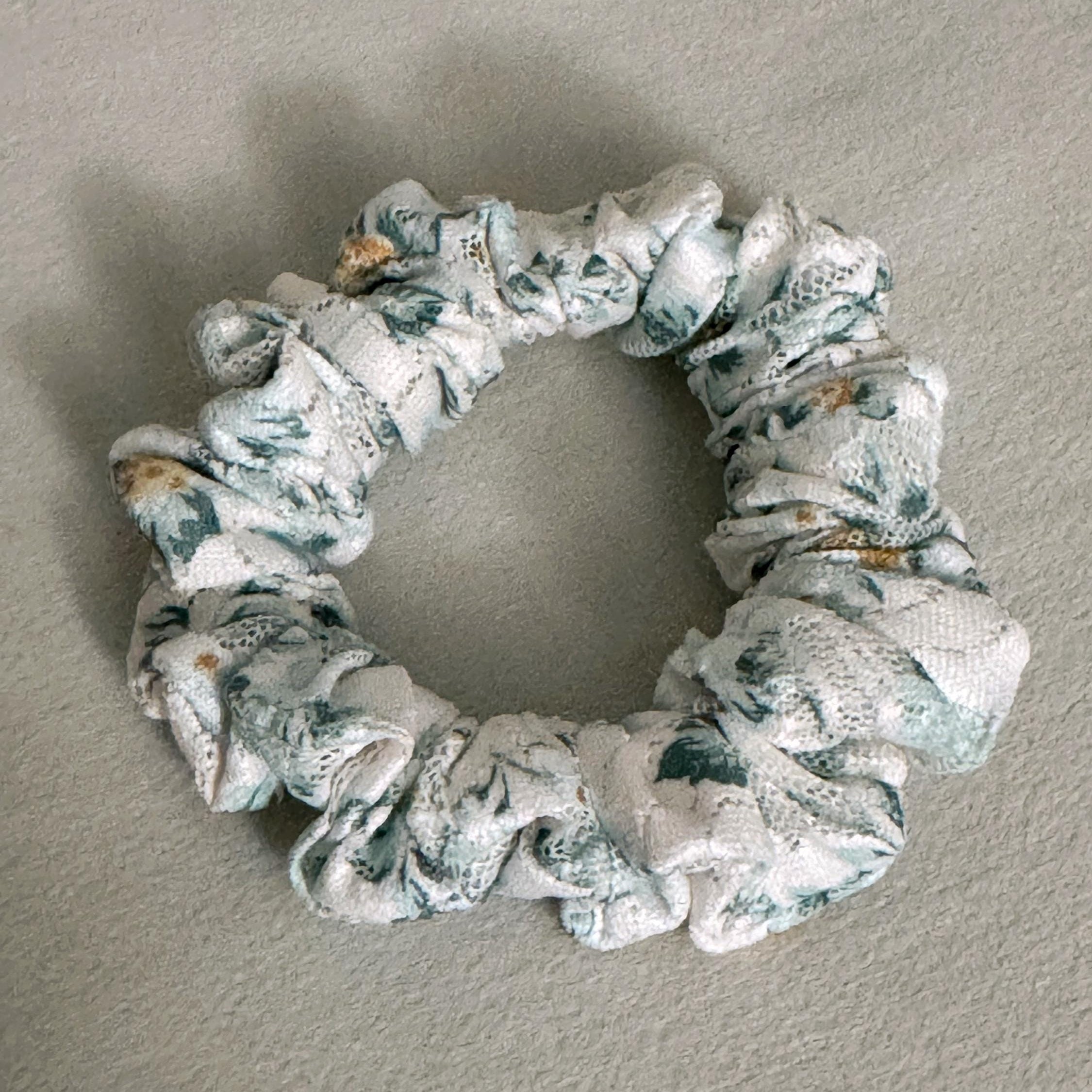 Floral patterned scrunchie on a plain background
