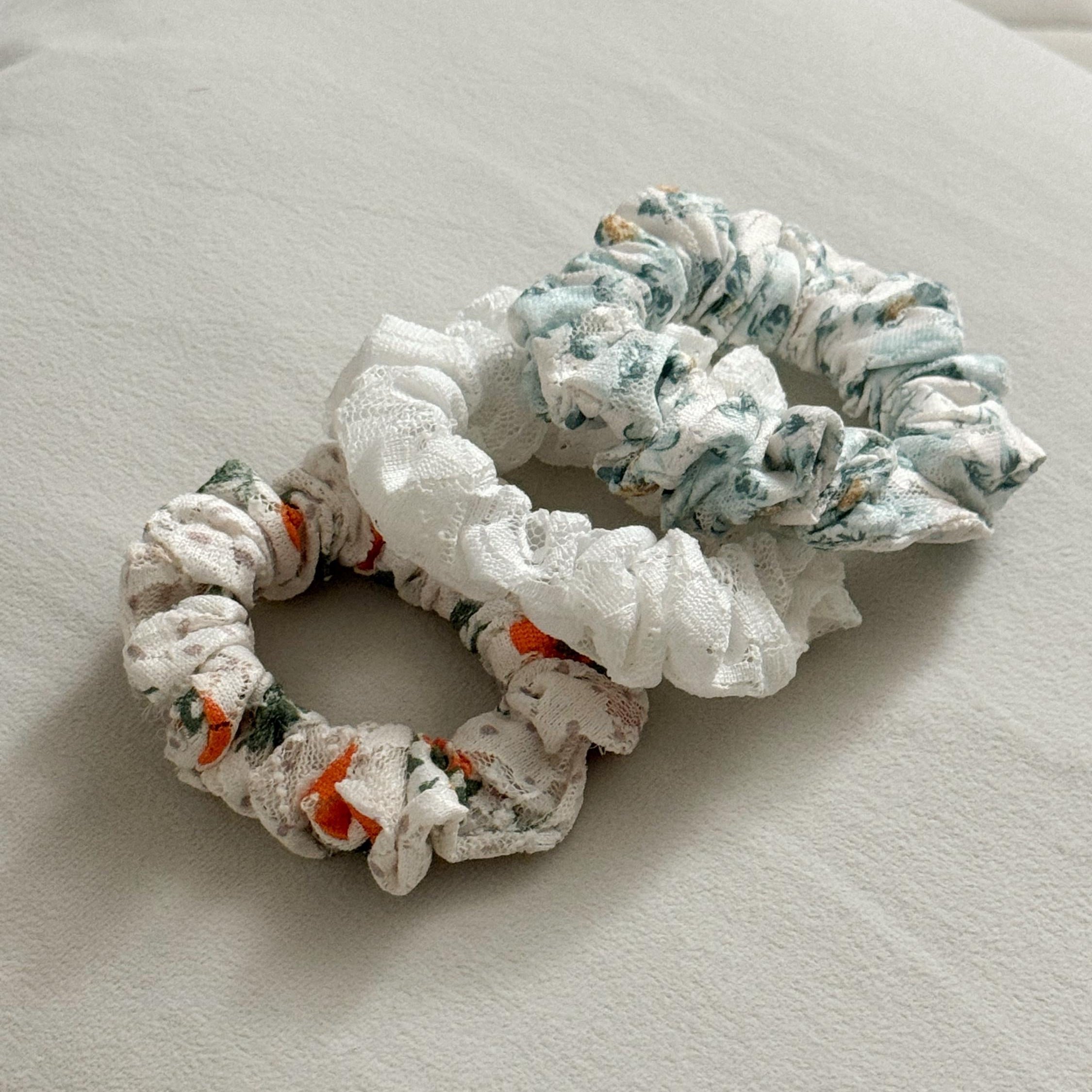 Two floral-patterned scrunchies on a light-colored surface