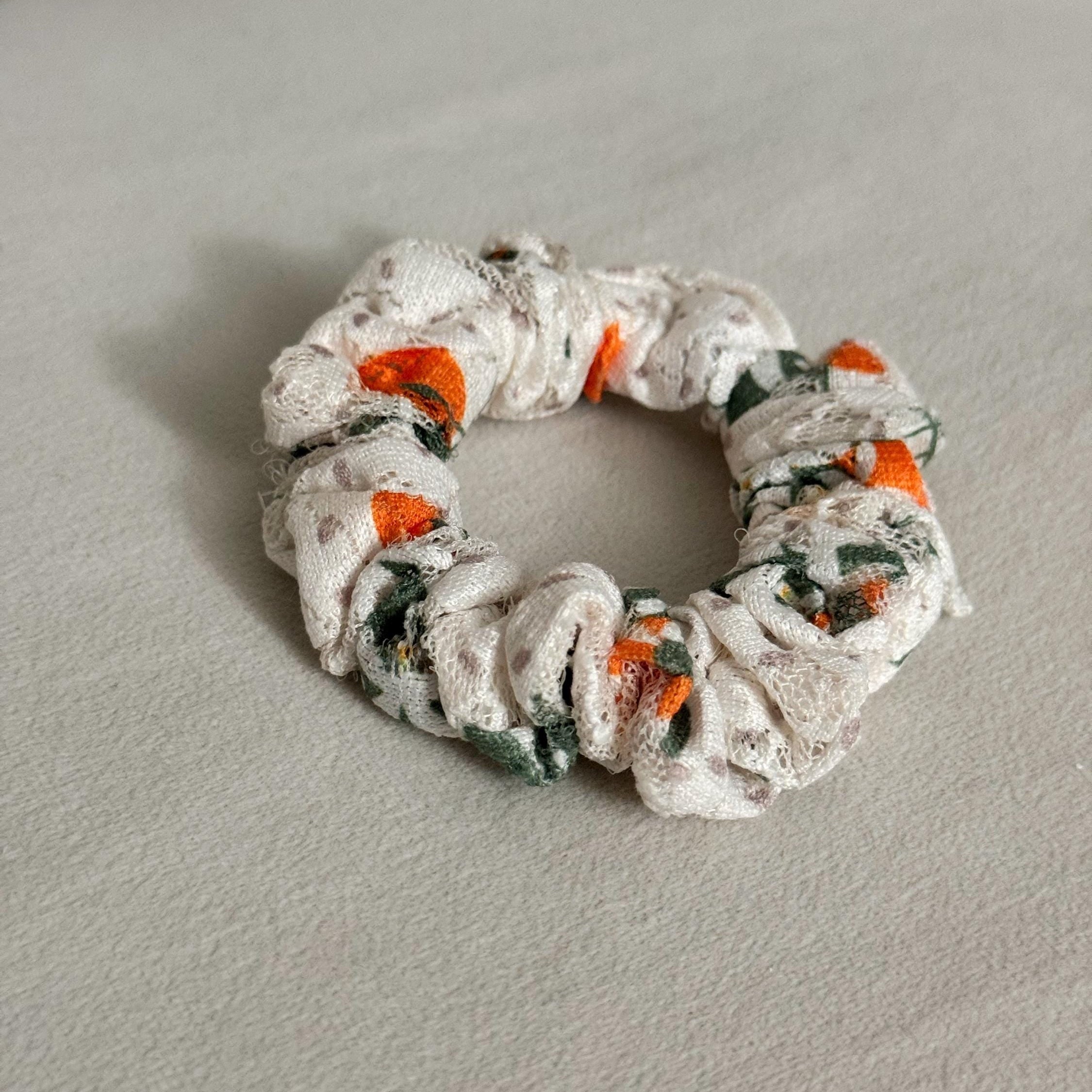 Scrunchie with floral pattern on a light gray surface